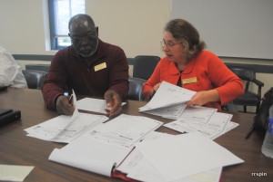Board members Clarence Pender and Sandy Partin review Halifax ballots.