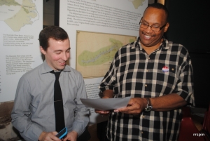 Spence, left, and museum historical interpreter Greg Cotton, participate in this morning&#039;s reading program.