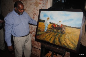 Hill shows his painting after its unveiling.