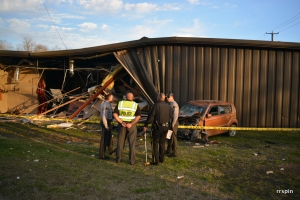 Troopers and officers investigate the damage.
