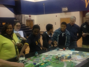 From left, William R. Davie Middle and Everetts Elementary STEM instructor Daria Johnson, Davie Robotics assistant coach and Exceptional Children instructor Cameron Foster, and students Claude Solomon, Artez Johnson, and Semaj Pierce look on during last week’s scrimmage. 