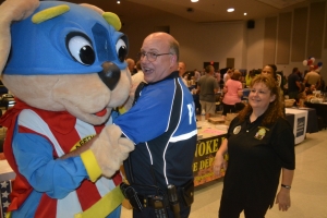 Lieutenant Charles Burnette of the Roanoke Rapids Police Department shares a laugh and a dance with Safety Pup.