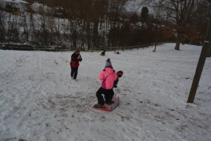 Children and parents frolic in the snow at T.J. Davis this afternoon.