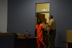 Simms is led into the courtroom this morning.