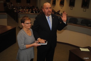 Tripp, with his wife, Karen, is sworn in today.