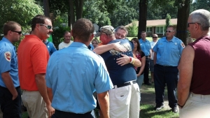 Firefighter Donnie Gums embraces Jean, face to camera, following his return home.