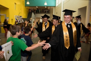 Graduating seniors greet the younger students Wednesday.