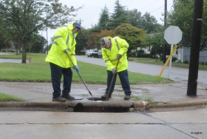 A public works crew checks a storm water drain on Hamilton Street.