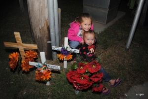 Denning&#039;s nieces pose beside the memorial placed in his memory at Tenth Street and Park Avenue.