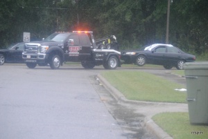 The car Cotton and Squire were shot in is towed away in this file photo.