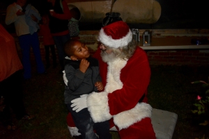 A child gives Santa his wish list.