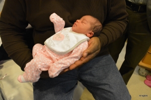 The baby in her father&#039;s hands.