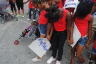 Girls hold hands during a prayer before the march.