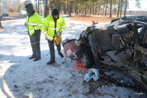 Troopers take measurements at the car from which the child was ejected.