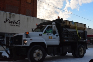 A public works truck drives down Roanoke Avenue.
